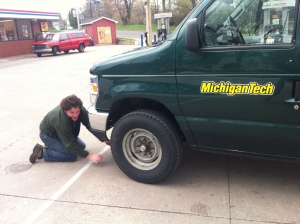 Sam Sweitz fixes a flat tire during a field trip.